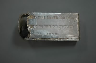 A hollowed-out 100 ounce (oz) Engelhard silver bar, that had been partially melted when it the lead insides were discovered, view from the top.