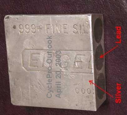 A 'drilled-and-filled' 100 ounce (oz) Engelhard silver bar, with three (3) drill holes filled with lead, cut in half.